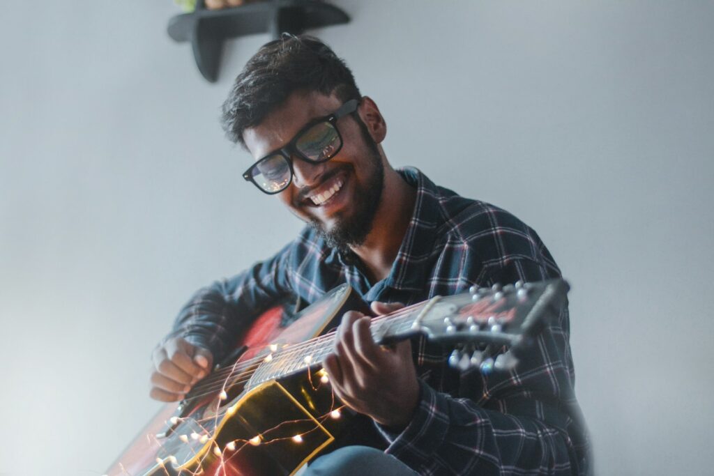 Guy Finding Joy Playing Guitar