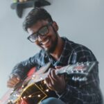 Guy Finding Joy Playing Guitar
